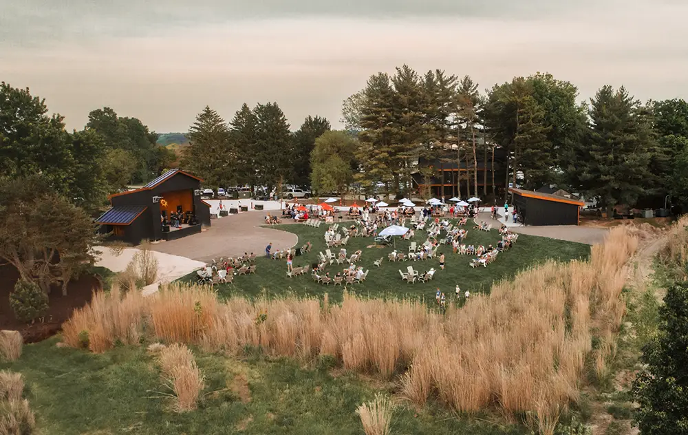Visitors listening to music outside on The Field at Cottle Village